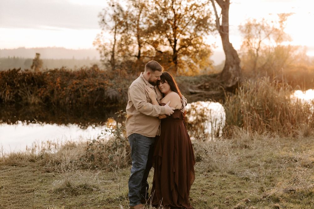 A romantic sunset engagement photoshoot in a golden field with warm autumn lighting and natural scenery.
