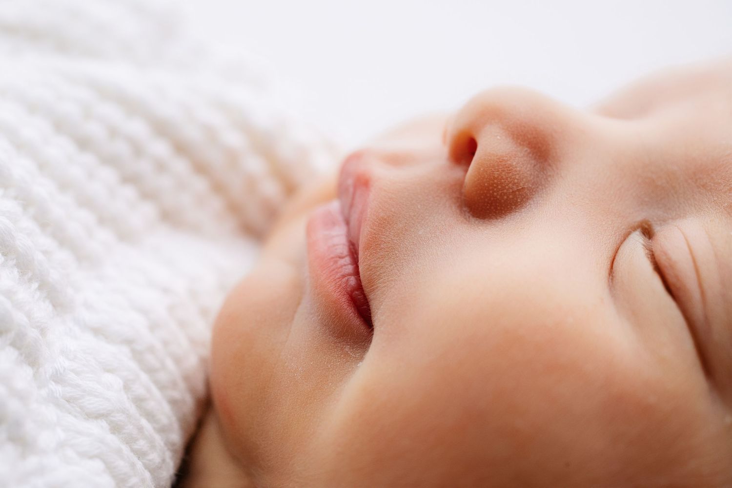 Close-up newborn portrait of baby lips captured in a Middle Tennessee newborn photography studio