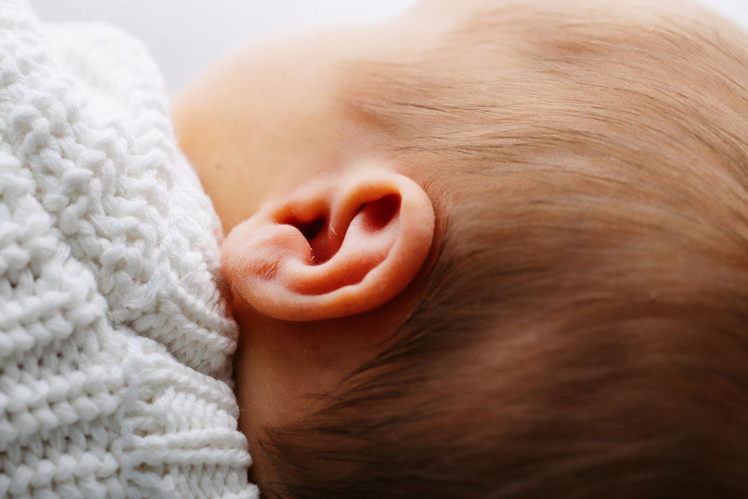 Close-up newborn portrait of baby ear captured in a Middle Tennessee newborn photography studio