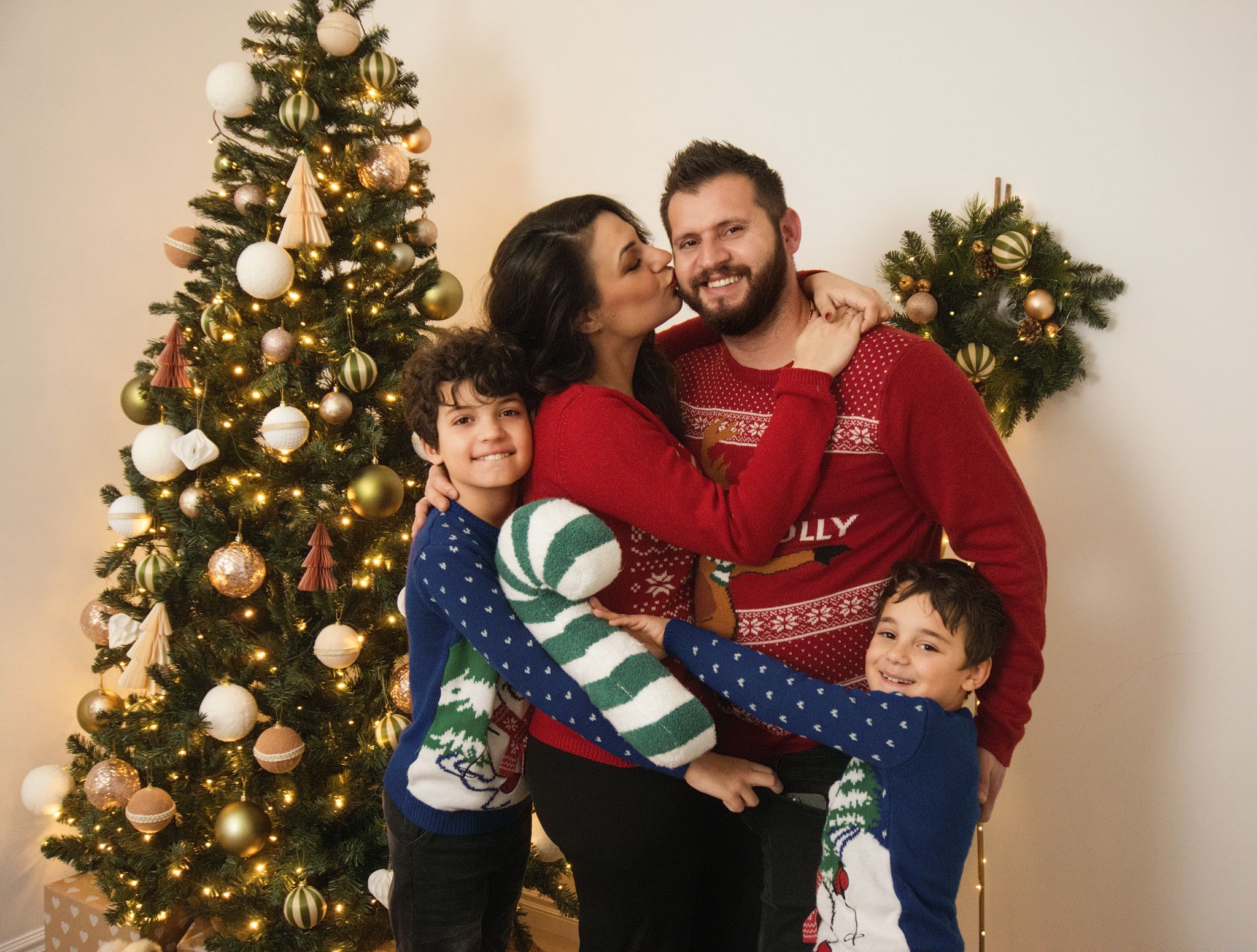 A family Christmas photo in a warm setting.
