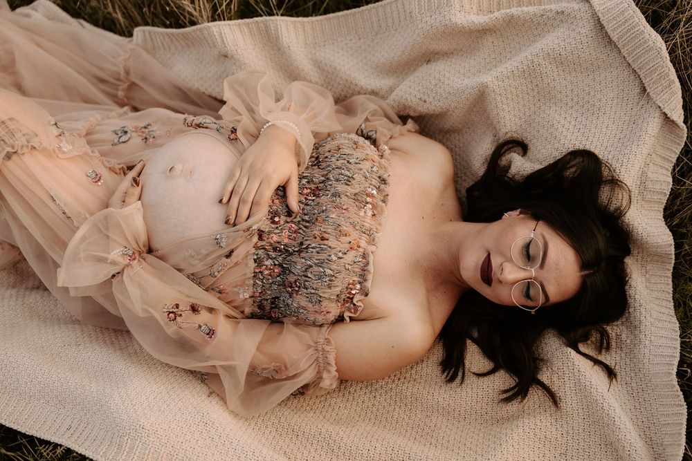 A boudoir photoshoot featuring a person in a lace dress lying on a bed in various elegant poses.