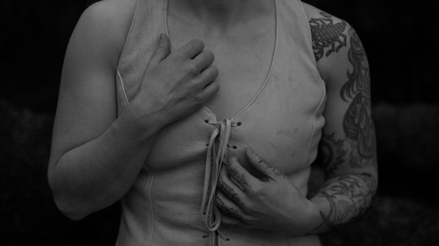 A series of black and white photographs showing a person holding their chest in different emotional poses.