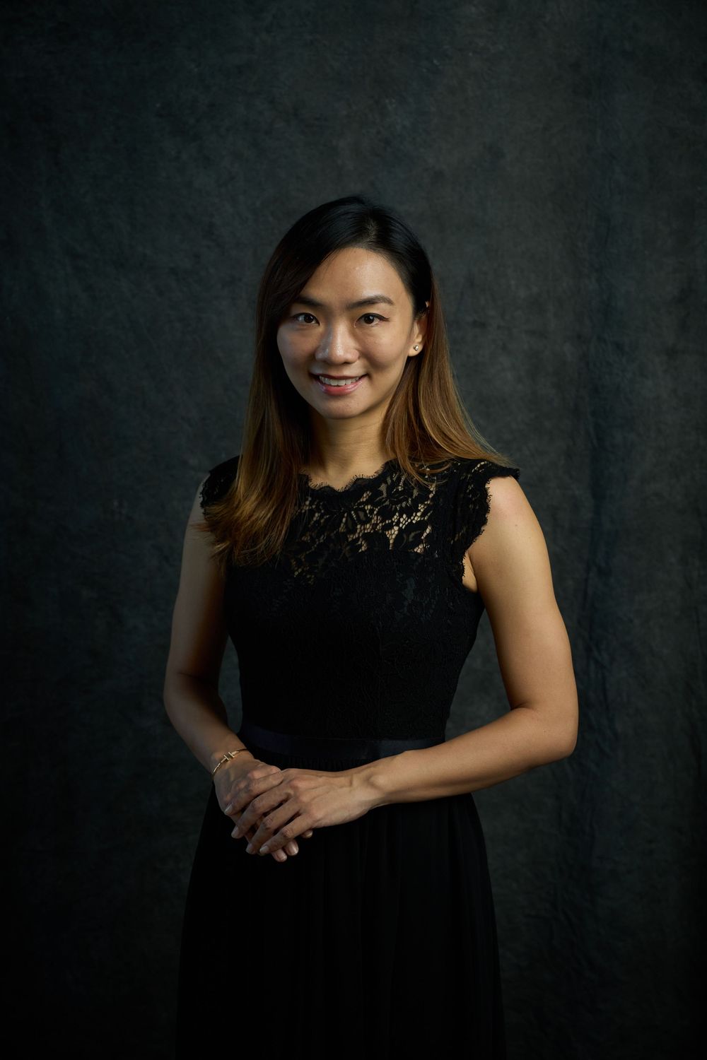 Professional portrait series of a woman in a black lace dress against a dark background.