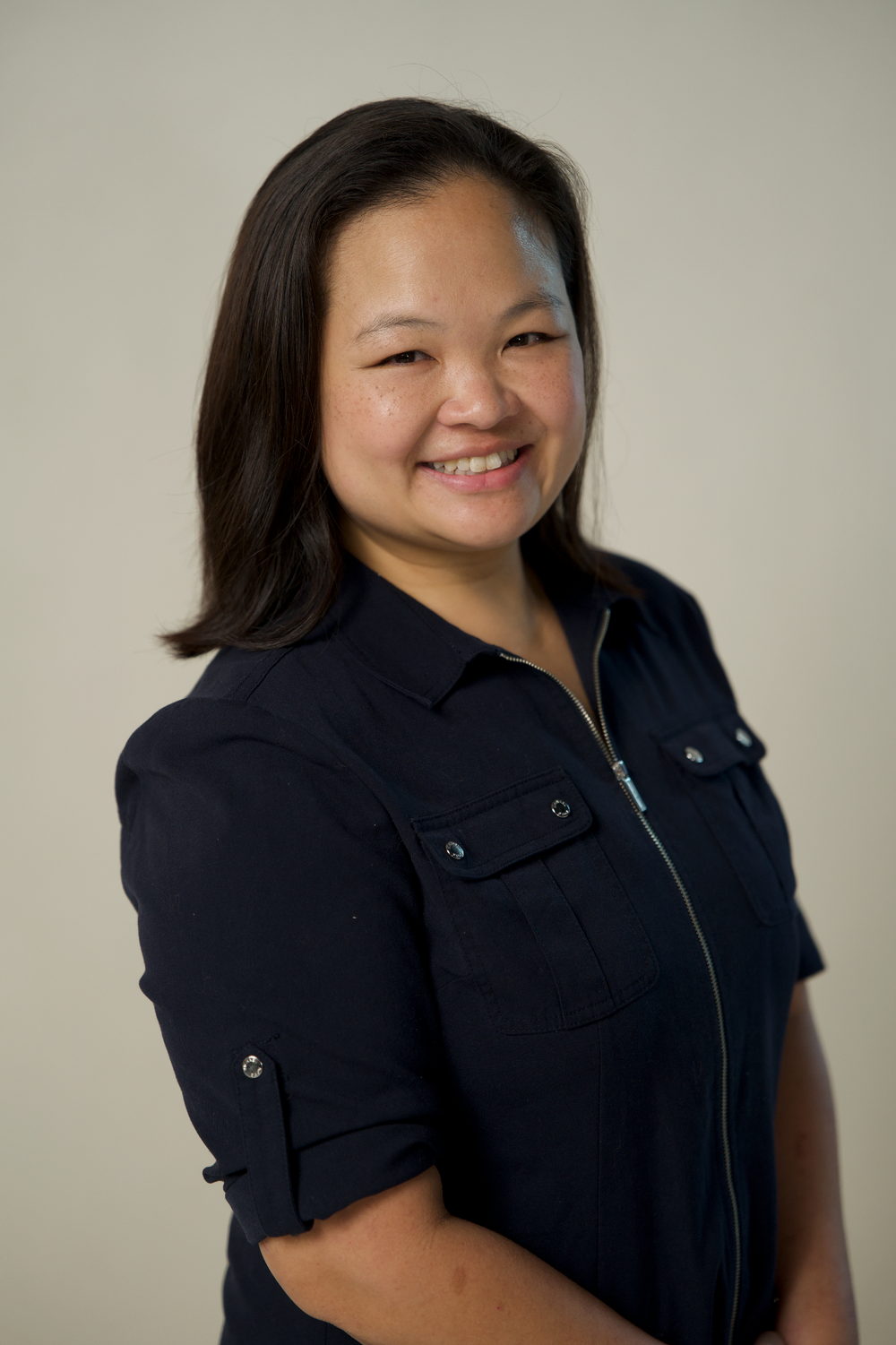 Professional portrait series showing a person in a navy blue collared shirt against a neutral background.