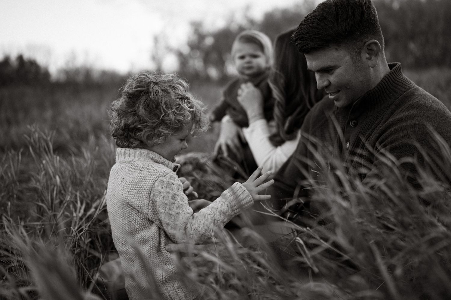 Black and white photo series showing family laughing at a lifestyle photo session