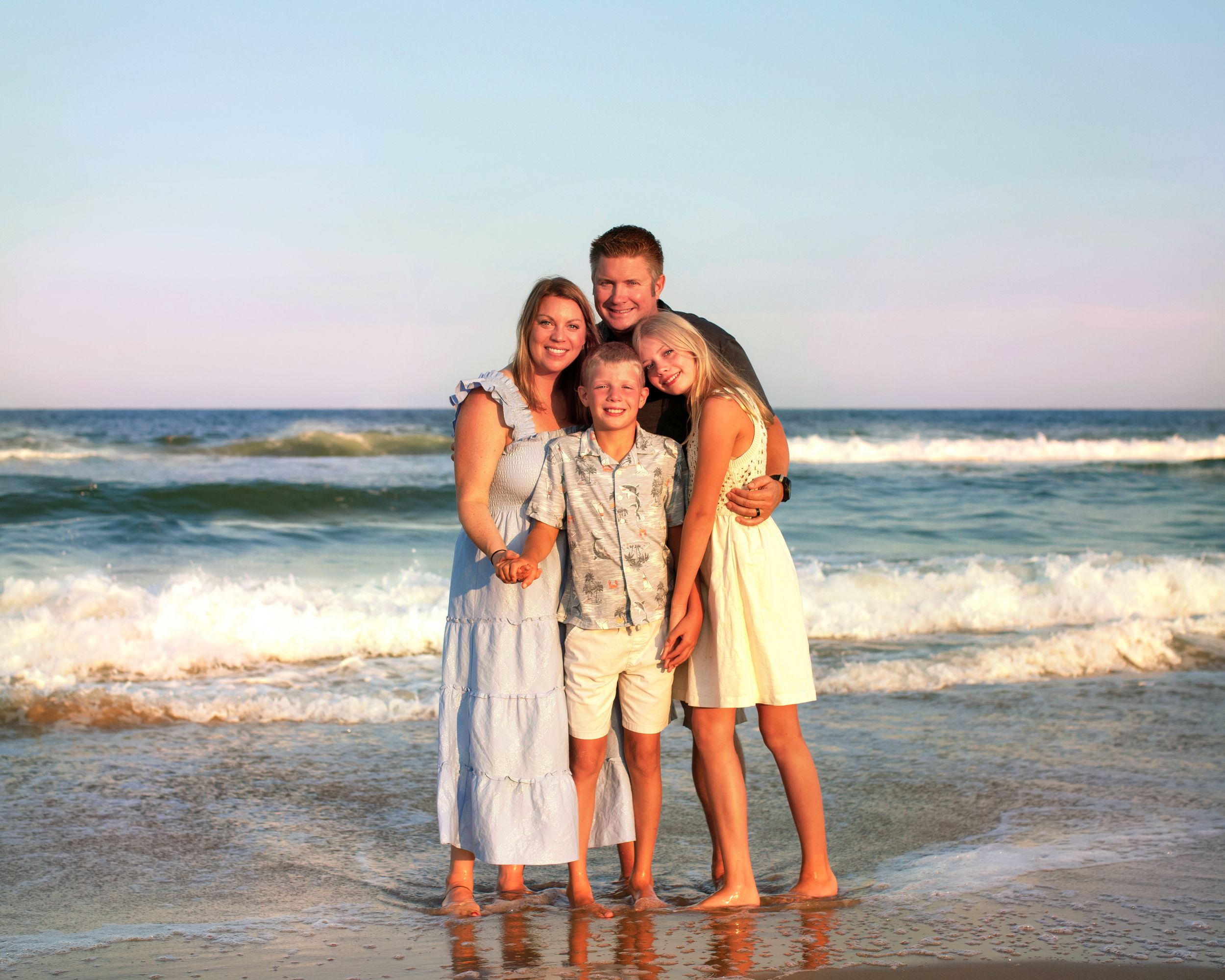 Bergen-County-Family-Photographer and LBI Family Photographer captures family hugging tight in water