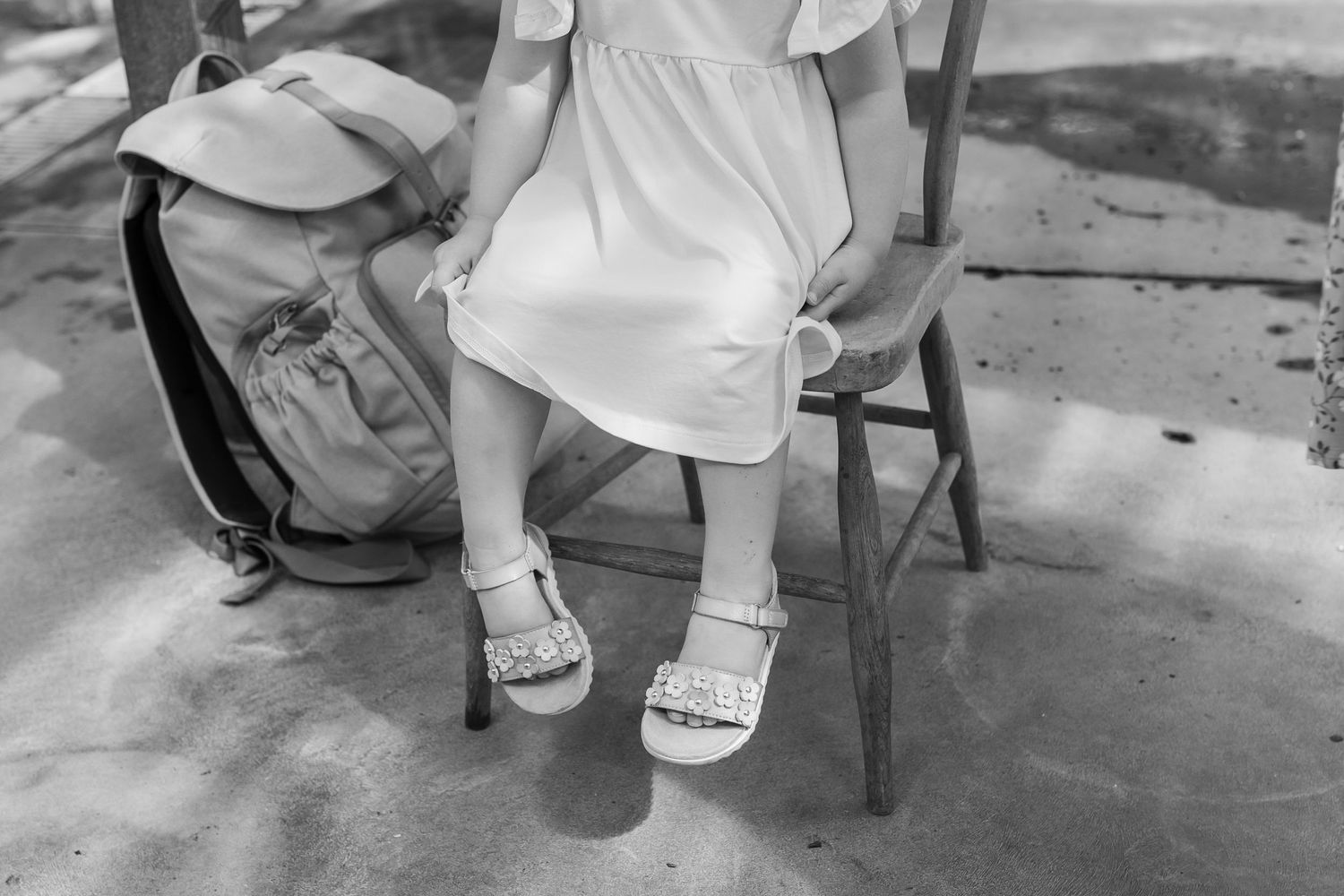 Black and white detail shots focusing on feet and lower bodies during a photo session.