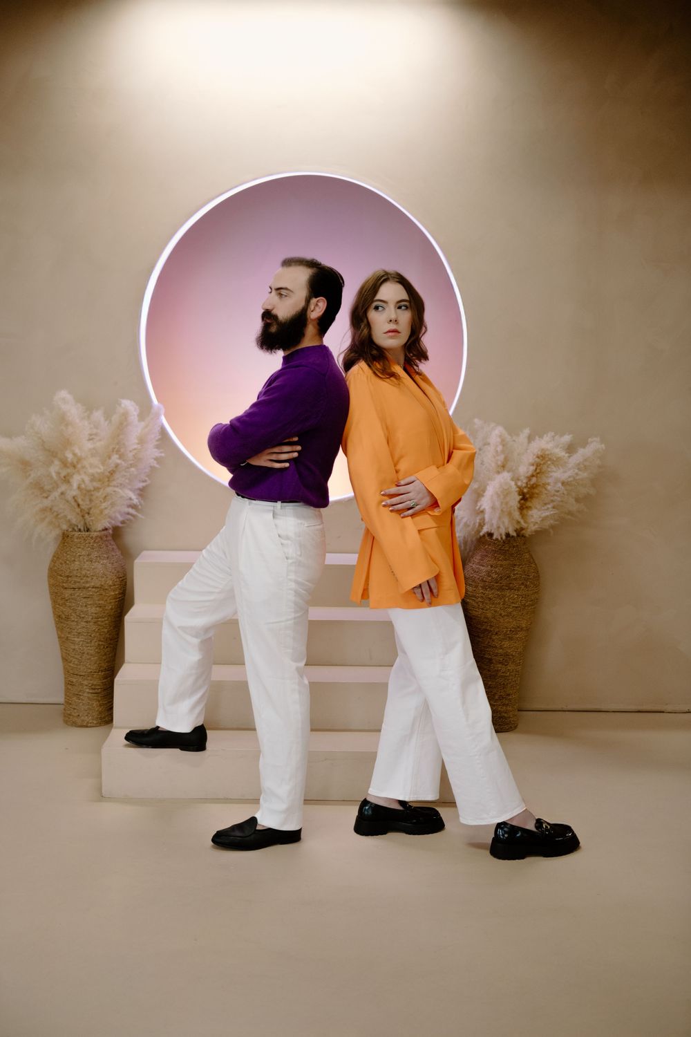 A stylized photo sequence of two people dancing and interacting against a beige backdrop with circular lighting effects.