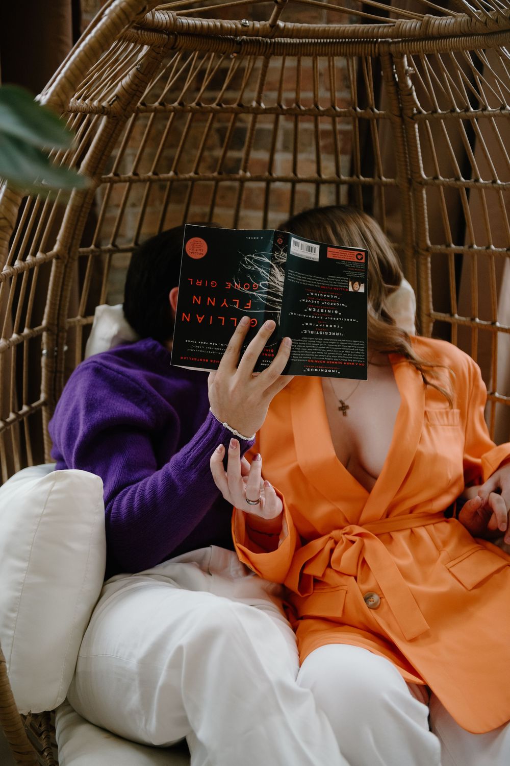 A sequence of five photos showing a stack of colorful orange, purple and white pillows with black text cards arranged on them.
