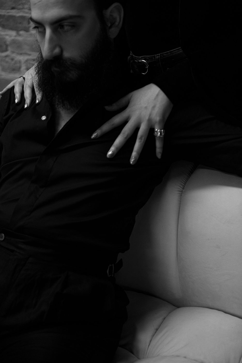 Artistic black and white photo sequence showing a person reclining in shadows with dramatic lighting and contrast.
