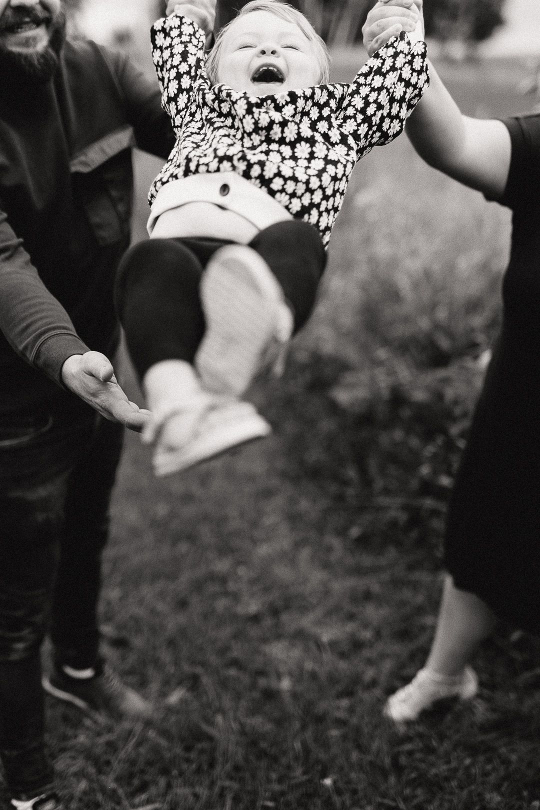 Black and white image showing polka dot dress details and movement against grass.