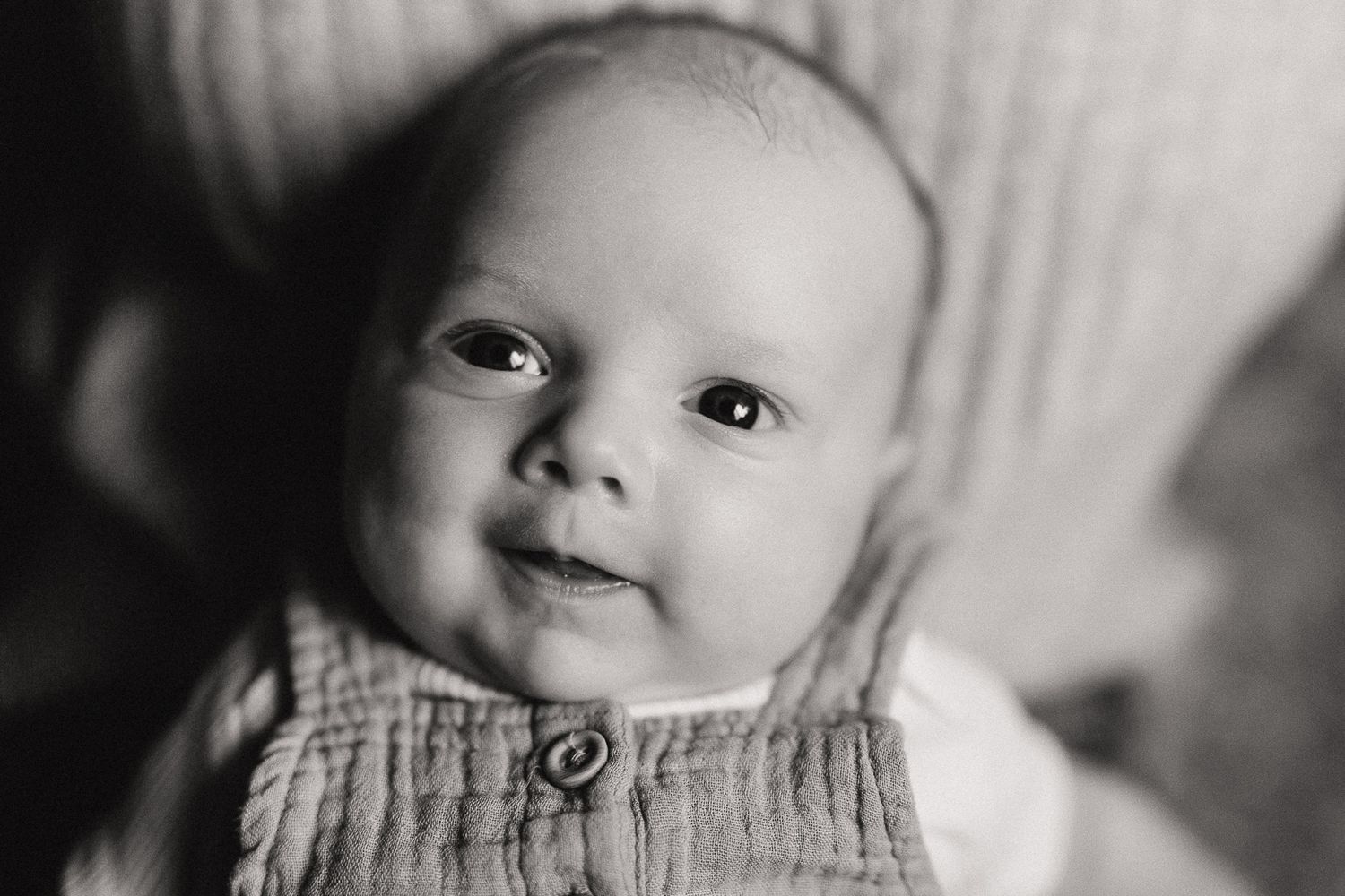 Close-up black and white portrait showing gentle expressions and soft lighting.