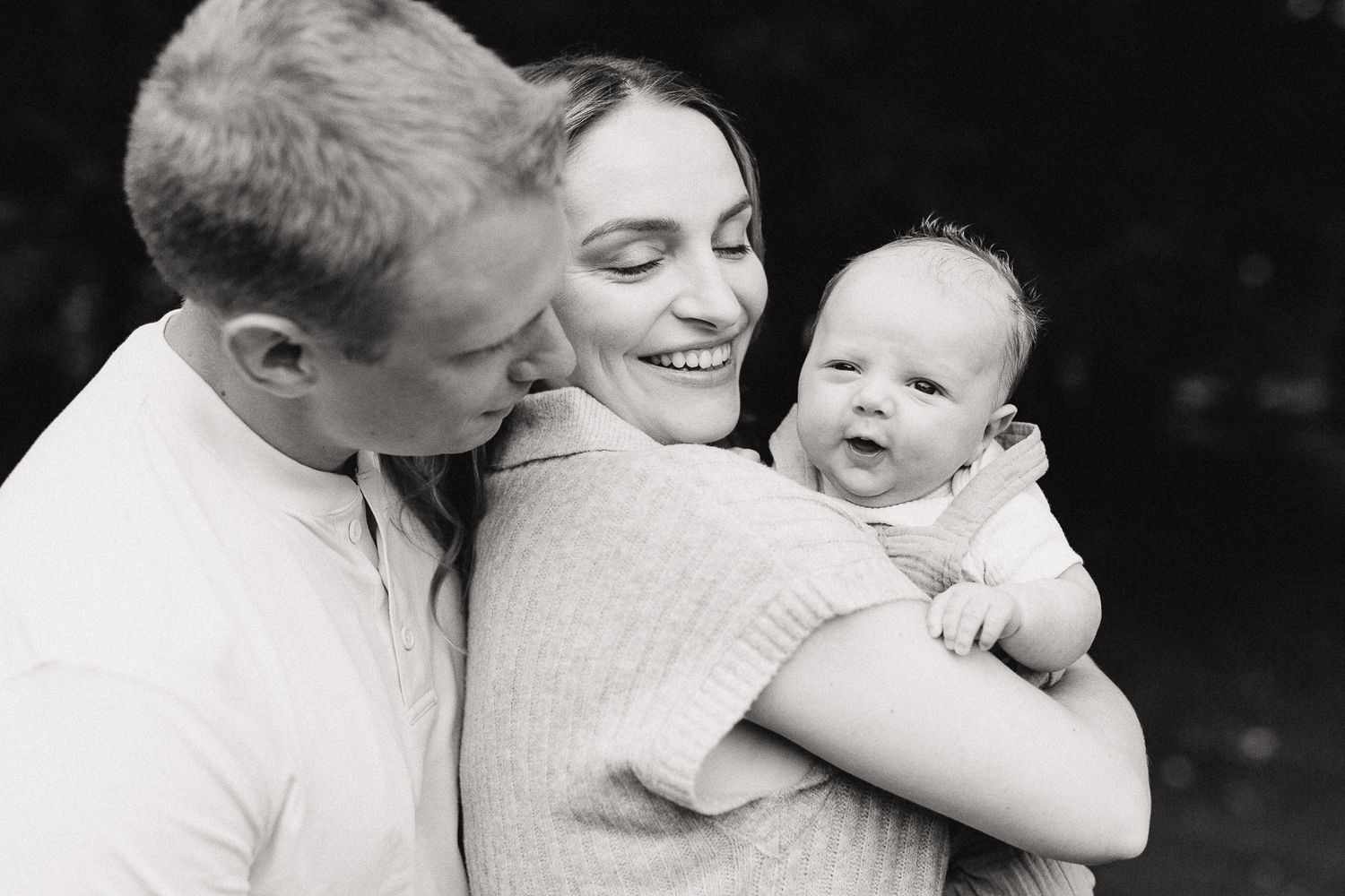 A tender family moment captured in black and white photography.