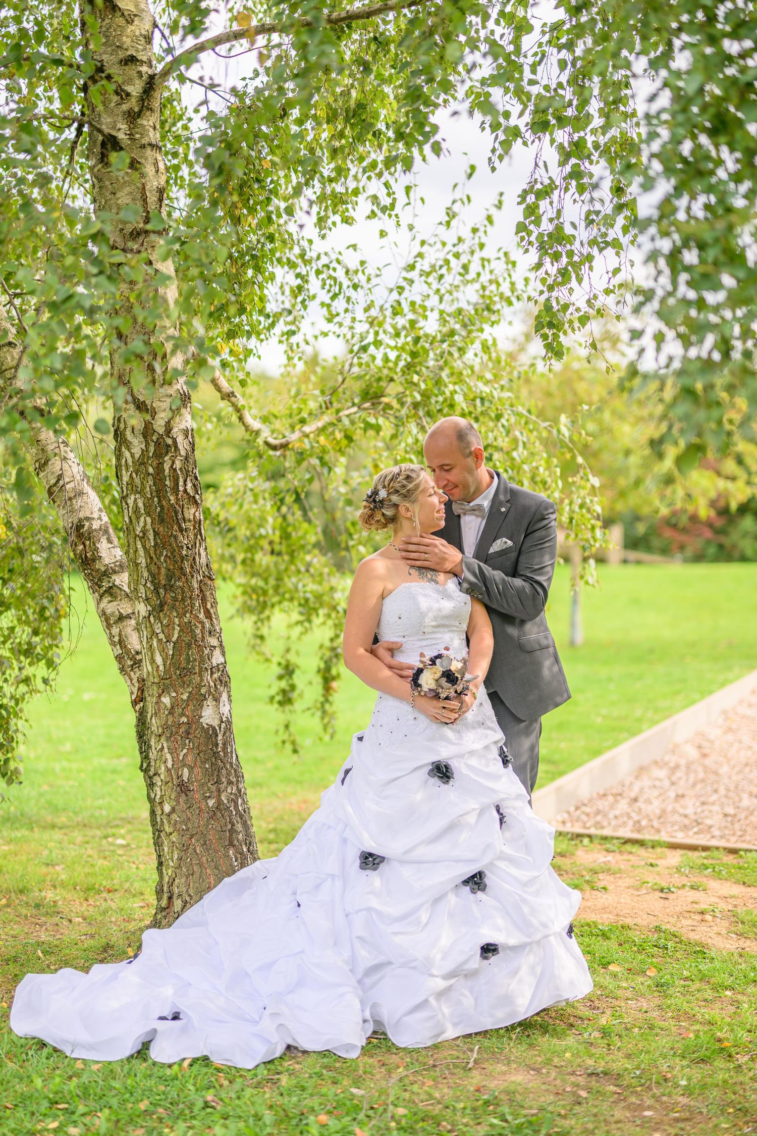 A romantic wedding couple poses in a series of elegant shots under stone archways at a historic European castle.