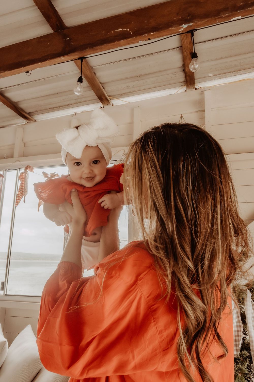 Playful interaction captured in a rustic white interior space.