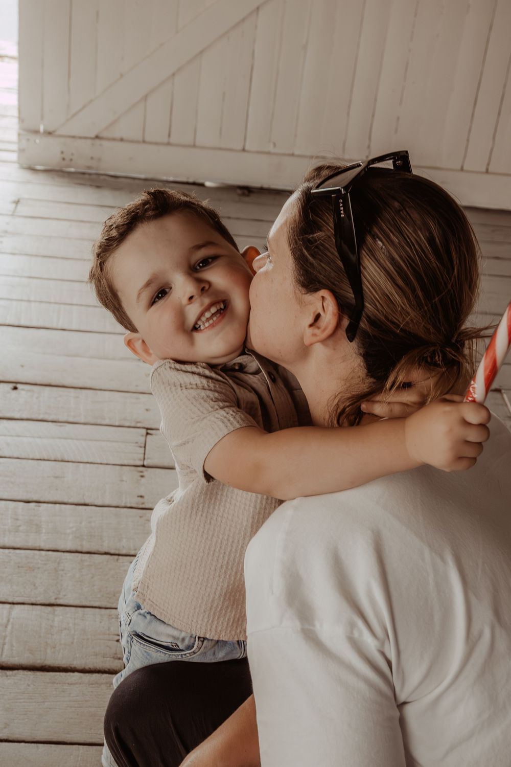 Joyful embraces captured in a bright white indoor setting.