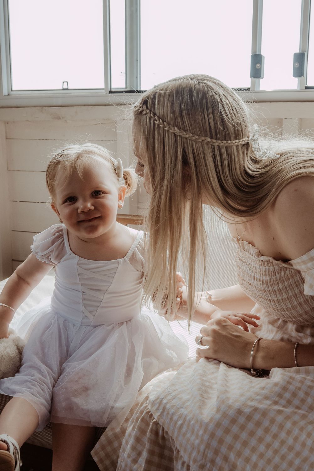 Sweet candid moments captured in soft light with white clothing.