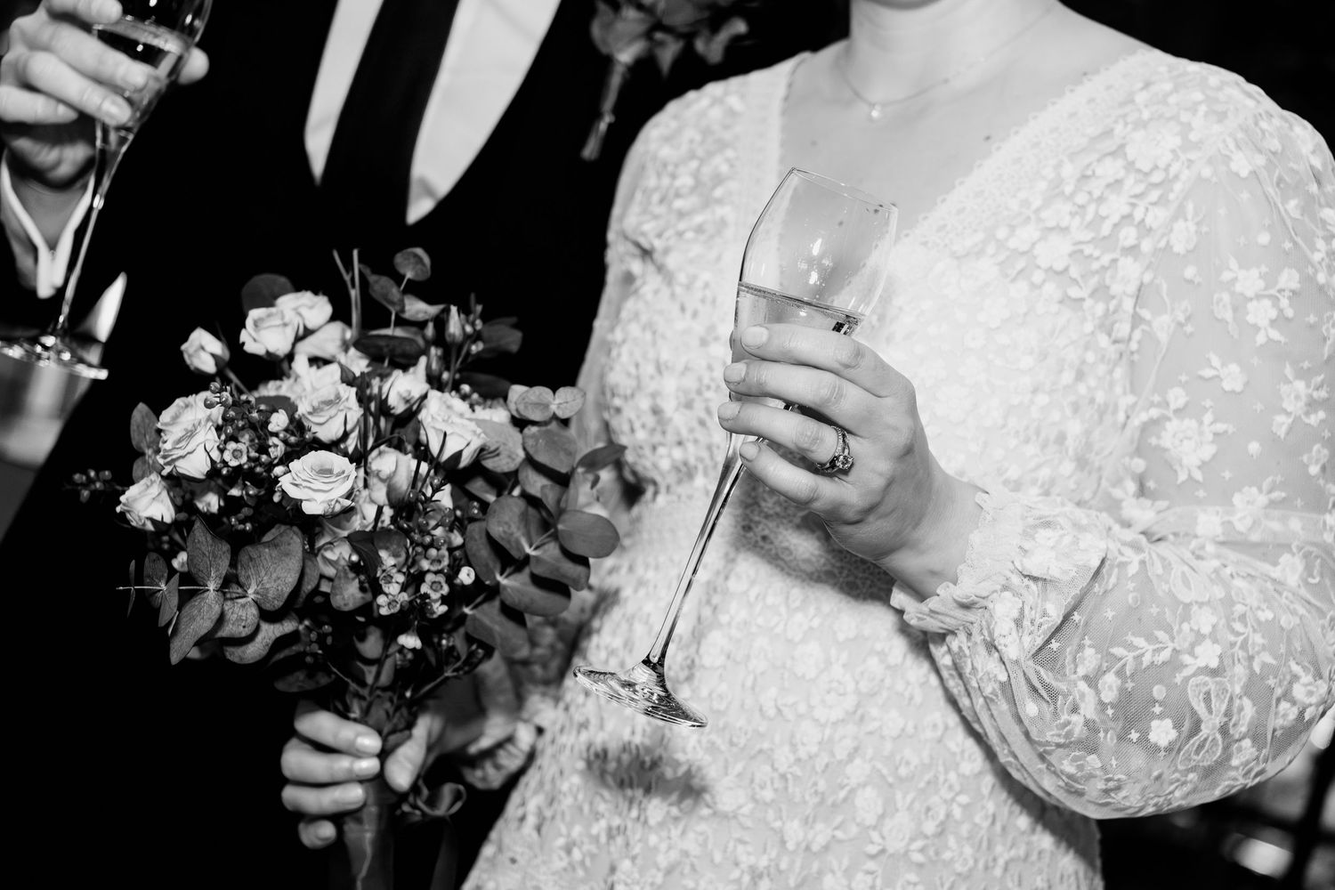 A series of black and white wedding photos showing couples dancing, embracing, and celebrating during a reception.