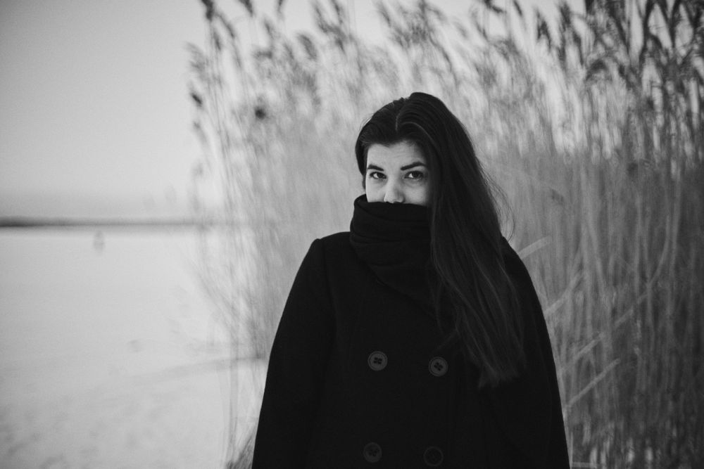 A series of black and white portraits showing a person in winter clothing against a snowy outdoor background.