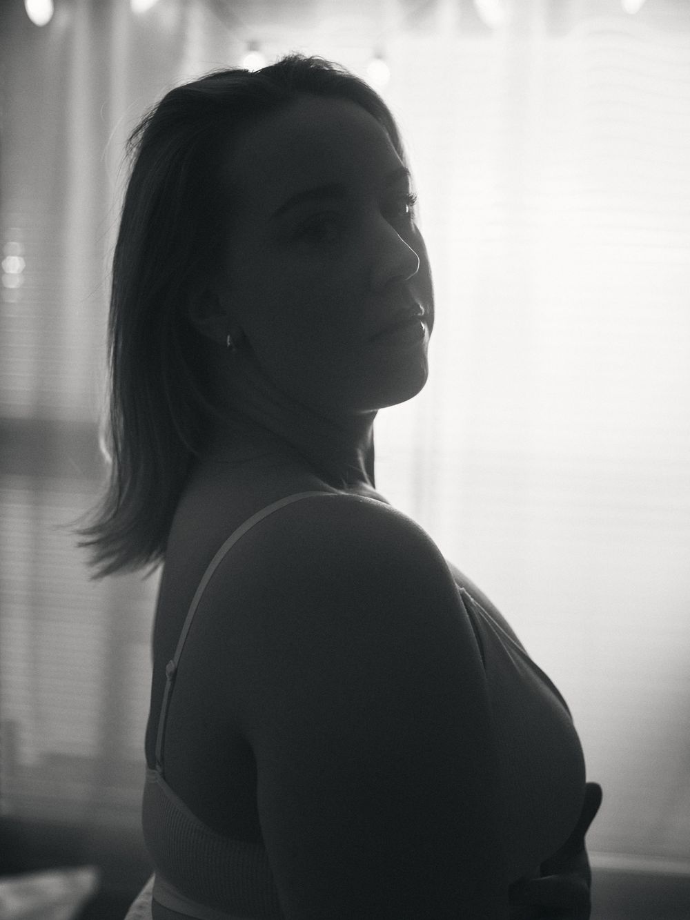 A dramatic black and white silhouette profile series showing a person in contemplative poses against a window backdrop.