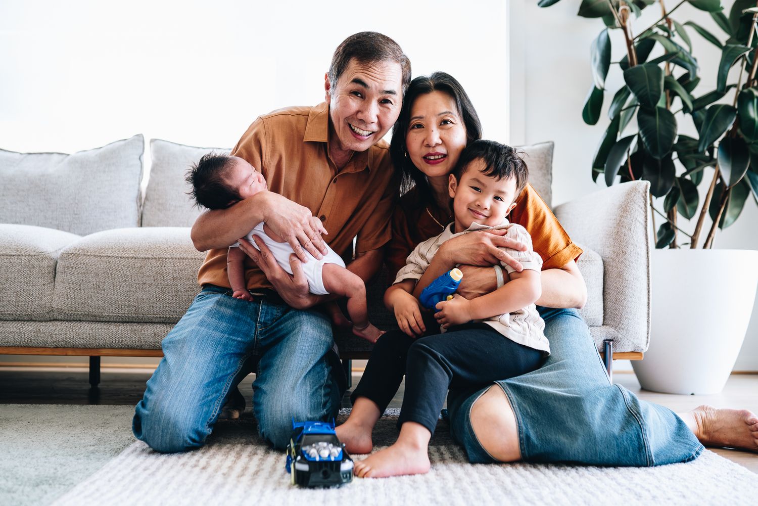 Family enjoying playful moments together at home in the living area taken by a Melbourne family photographer.