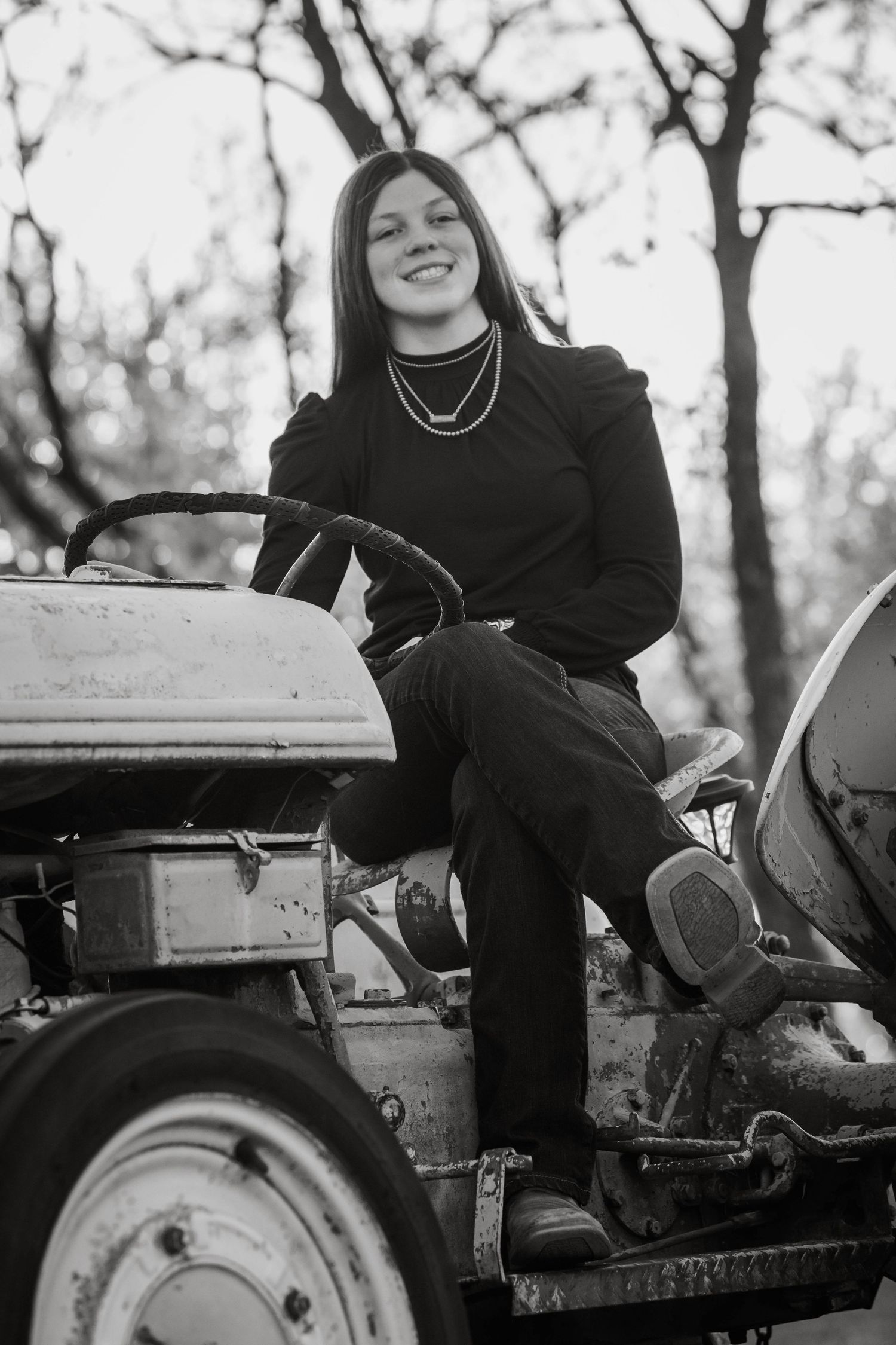 Black and white portrait series on vintage tractor in rural setting.