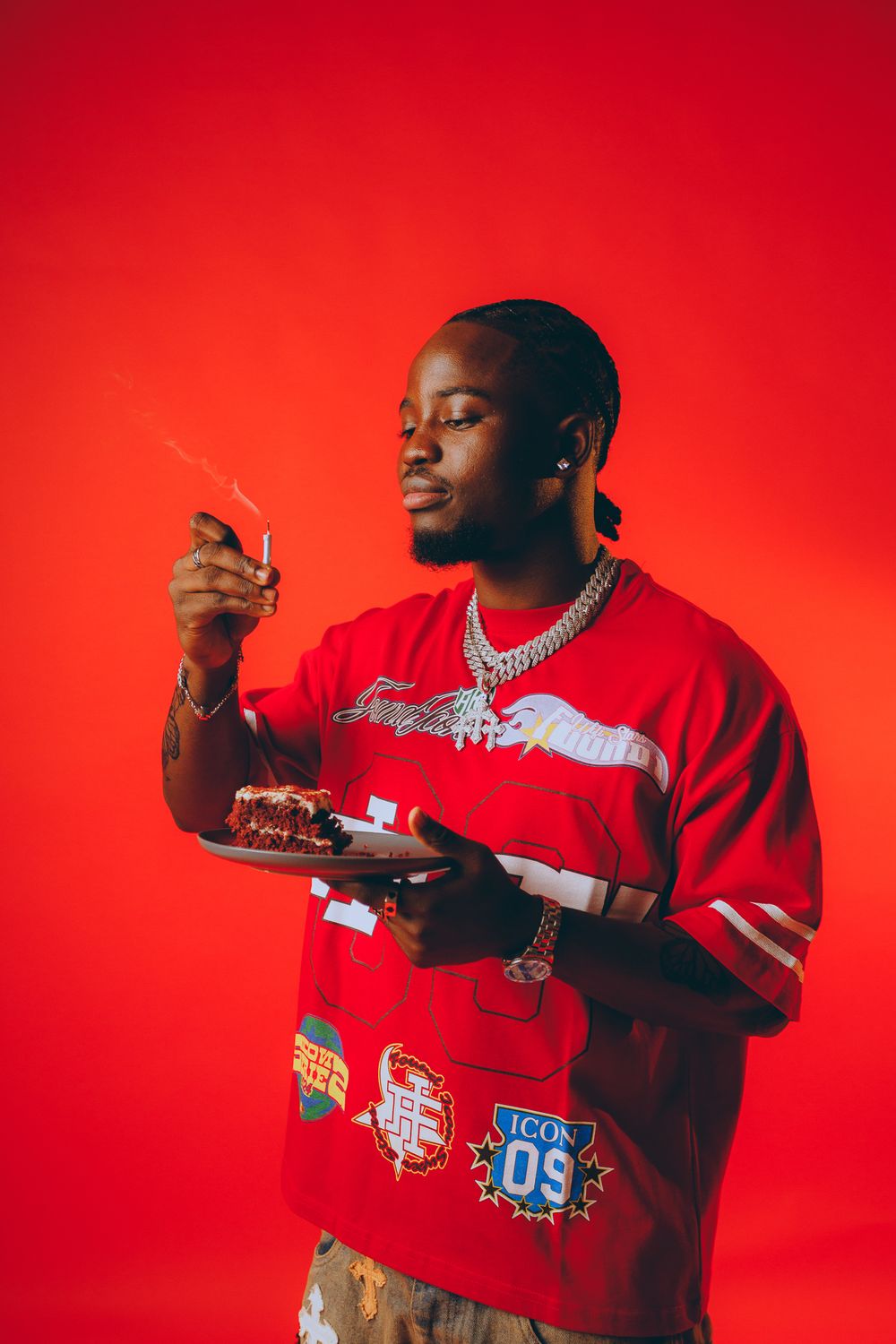 Person in red sweatshirt holds plate against vibrant red background in creative portrait series.