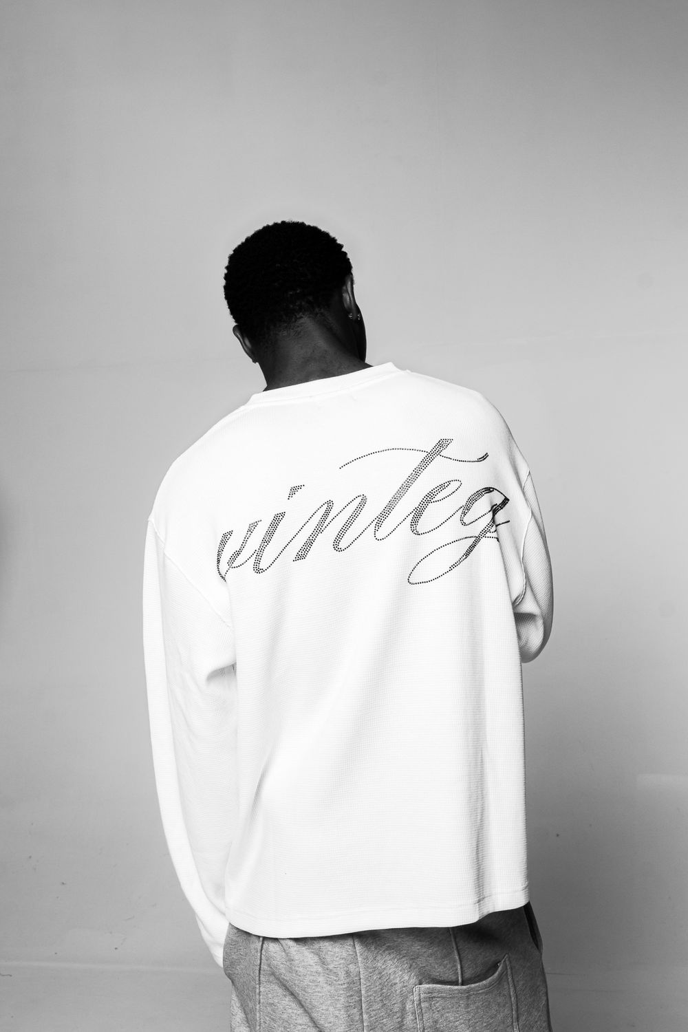 Black and white photo series showing a person in a white shirt with text, viewed from behind against a plain background.