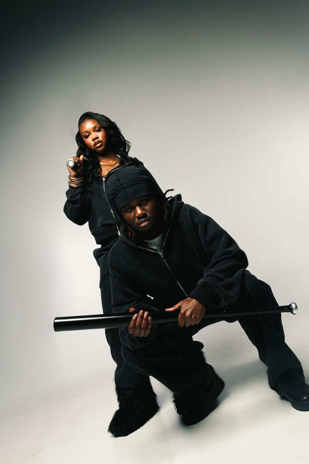 Figure in black clothing strikes dynamic poses against white backdrop in artistic photo sequence.