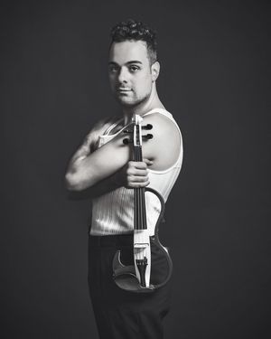 Black and white portrait series showing a violin musician in dramatic lighting and various artistic poses photographed in NSW by Wollongong