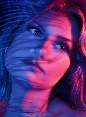 Artistic portraits with neon lighting creating a dreamy motion blur effect. Photographed by Wollongong Portrait Photographer Serene Coleman