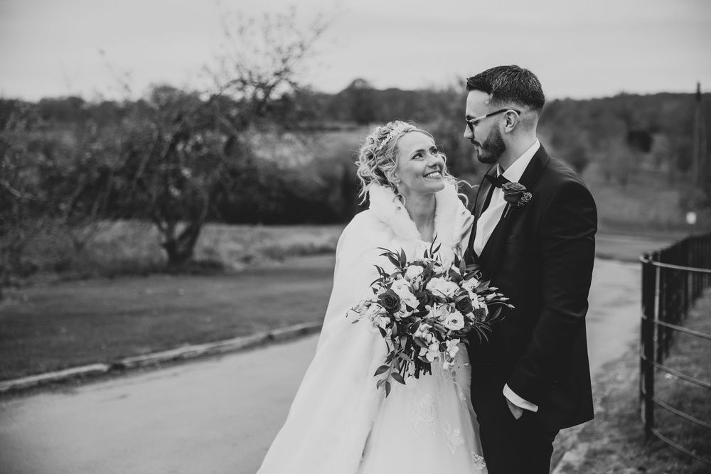 A black and white wedding photo collage shows romantic moments between a couple in an outdoor setting.