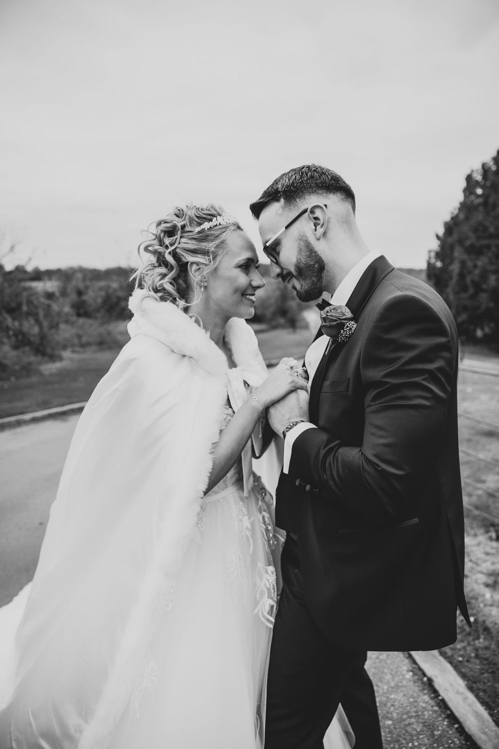 A series of candid black and white wedding photos showing tender moments between newlyweds.
