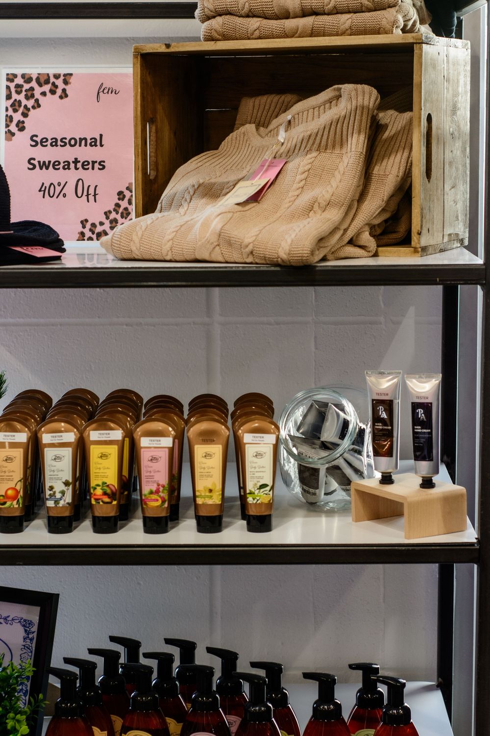 Retail display shelves stocked with coffee beans and merchandise in a modern coffee shop setting.