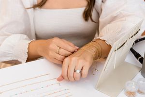 Layered gold permanent jewelry bracelets photographed for luxury jewelry branding session in Jupiter Florida studio.
