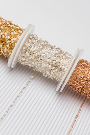 Pastel permanent jewelry chain spools photographed in luxury branding session for jewelry business in Jupiter Florida.