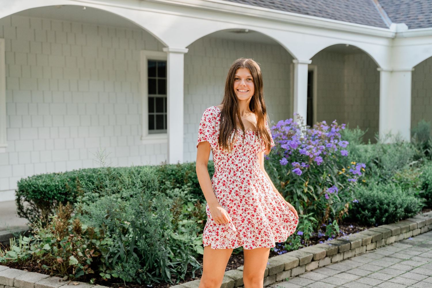 Spring Toledo senior photography with floral backdrop
