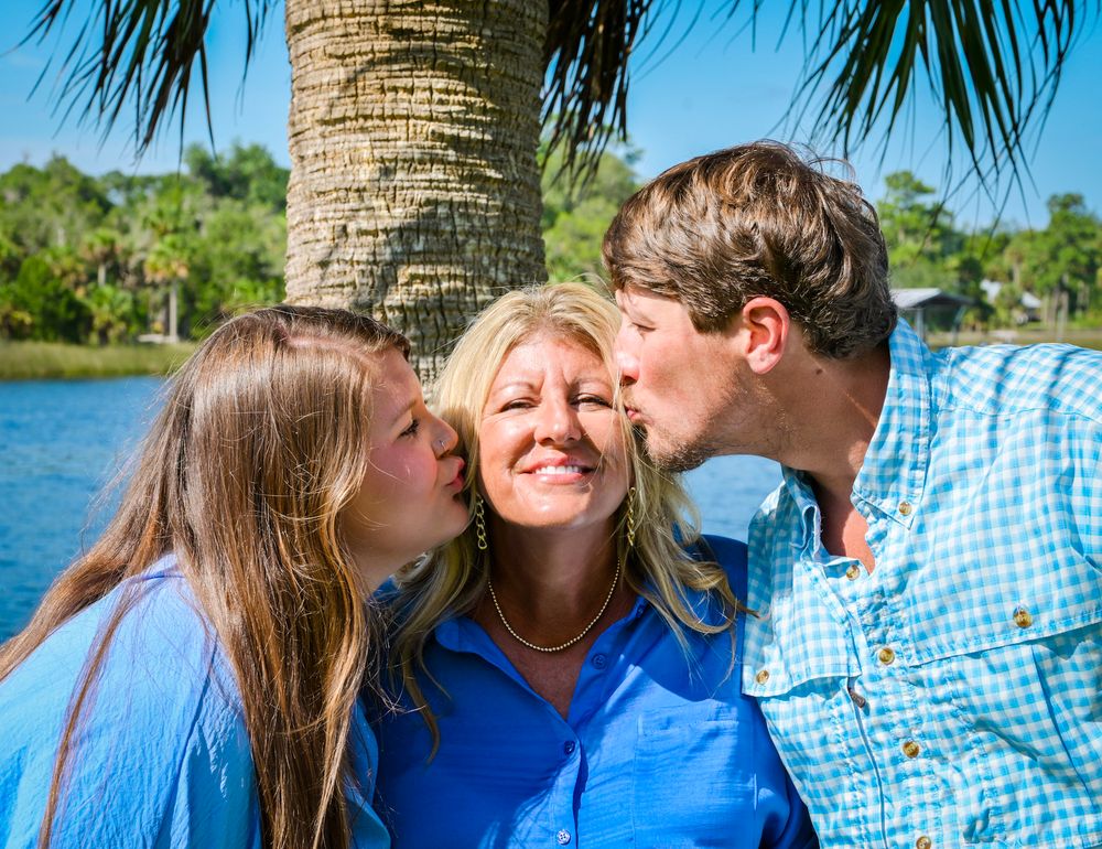 A series of candid family photos taken outdoors near palm trees and water on a sunny day.
