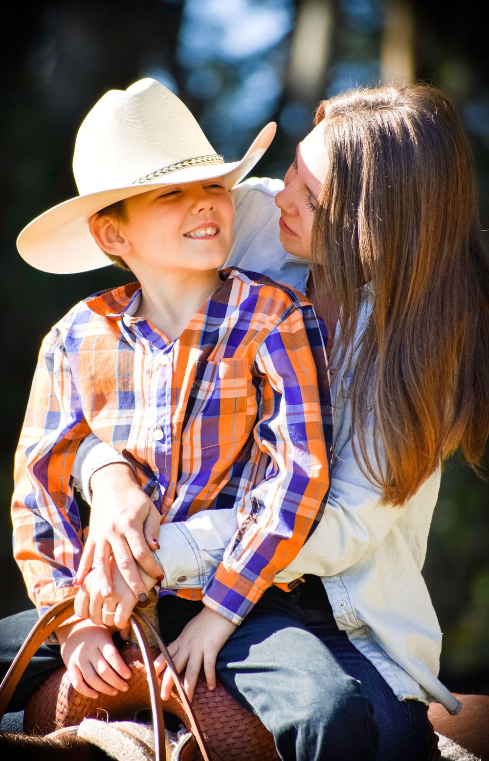 A romantic couple in plaid and white clothing shares tender moments outdoors in a series of connected photos.