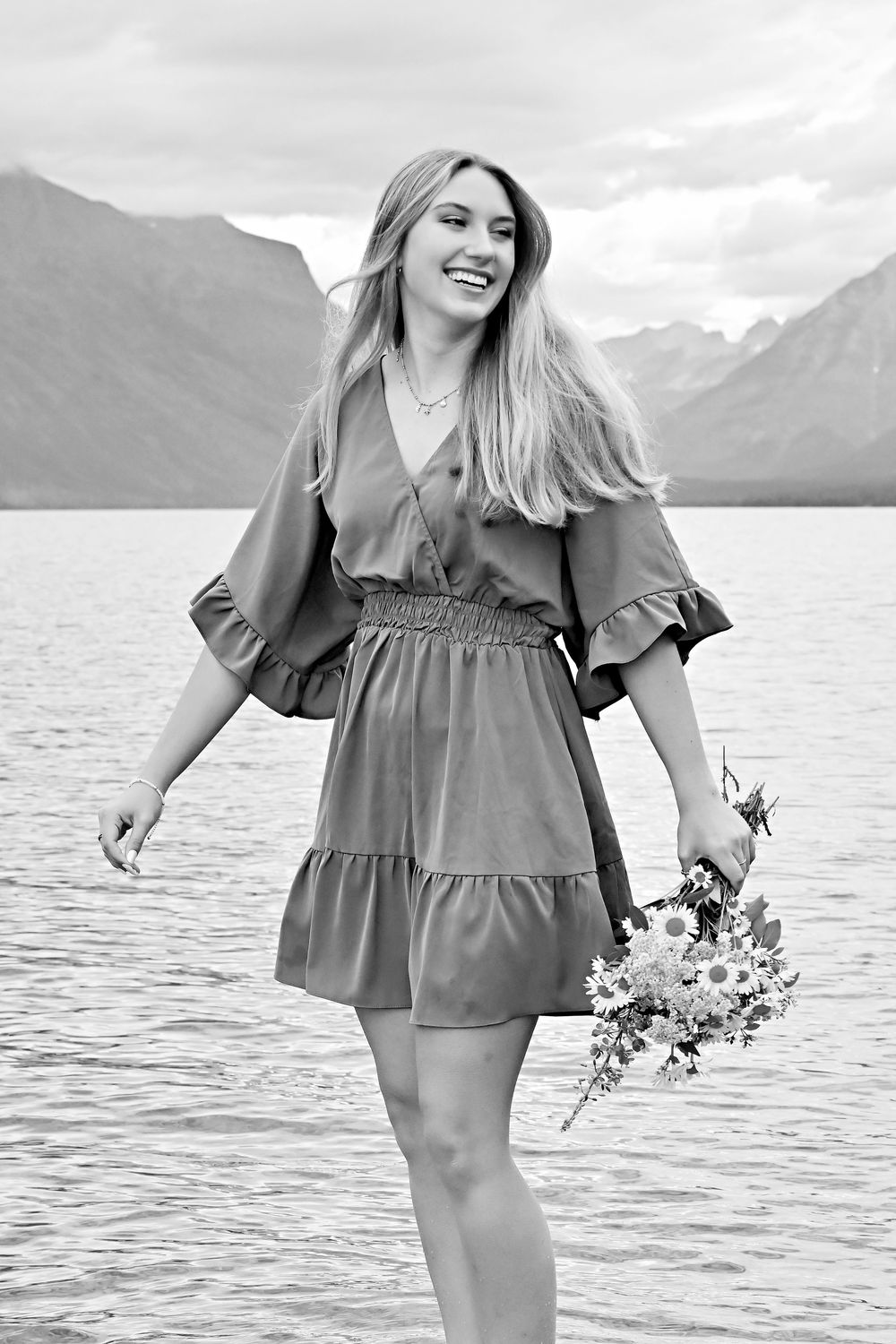 senior portrait walking on water in lake McDonald in glacier national park montana