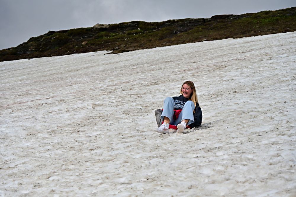 sledding down Logan pass in glacier national park