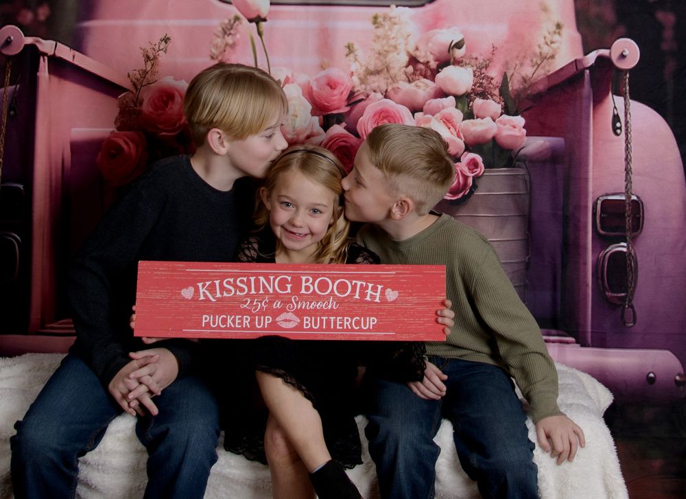 A pink-themed photo booth collage showing couples sharing romantic moments at a kissing booth attraction.
