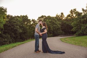 Romantic outdoor photoshoot on a winding path at sunset with dramatic poses.