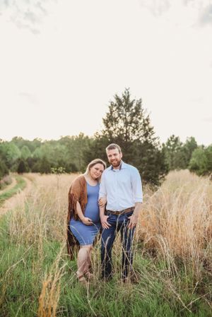 Couple sharing intimate moments in a golden wheat field during golden hour.