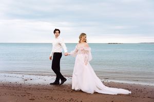 A couple pose in wedding attire