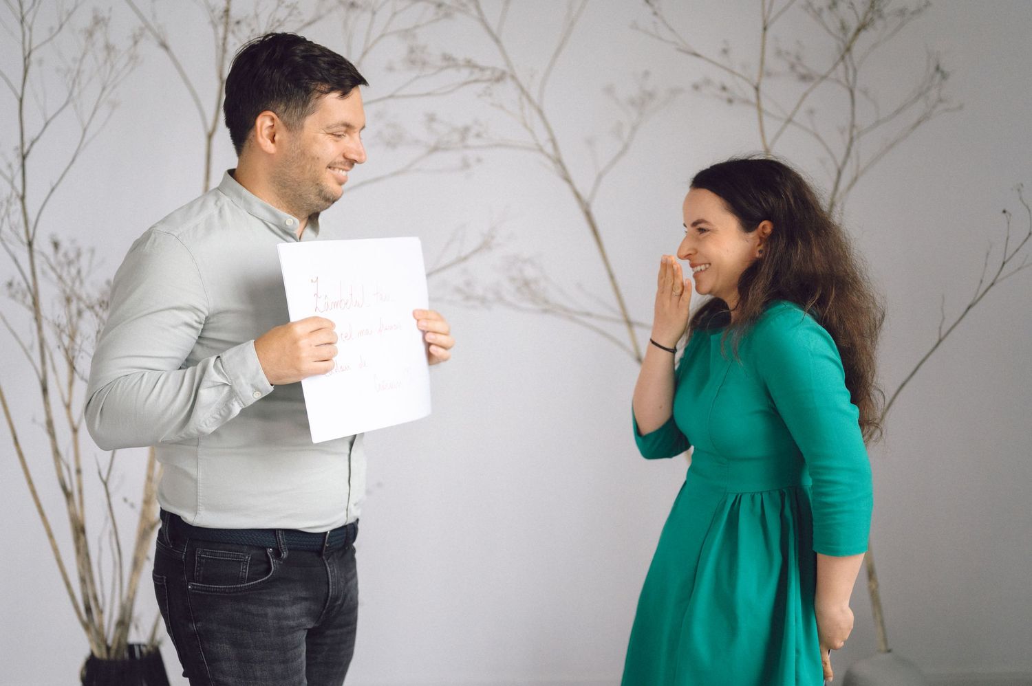 Two business professionals engaging in a conversation while reviewing documents in an office setting.