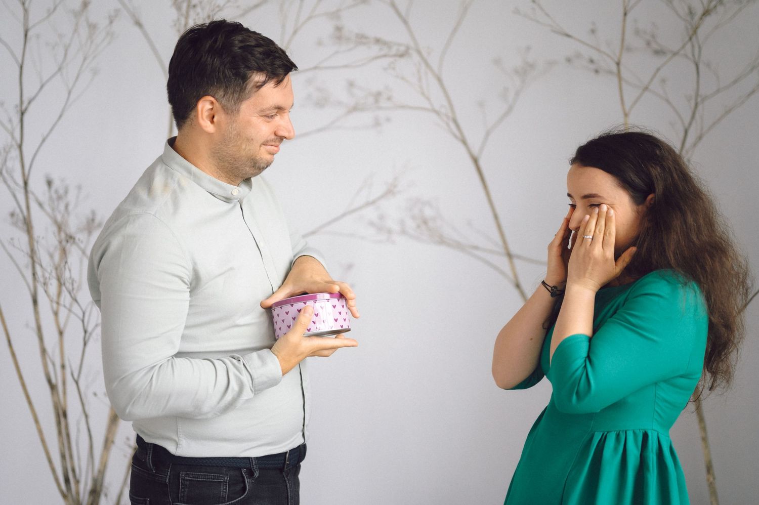A series of candid photos showing a playful couple in white and green outfits interacting with each other against a light background.