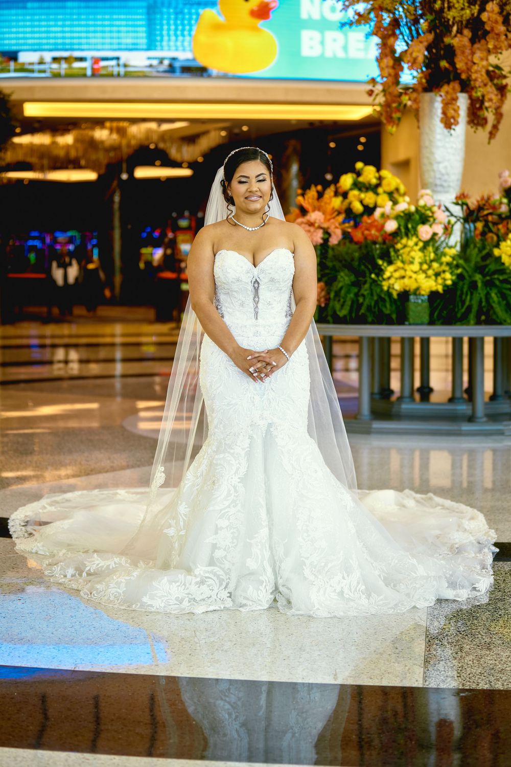 Stunning bridal portraits in a modern venue with reflective floors and ambient lighting.