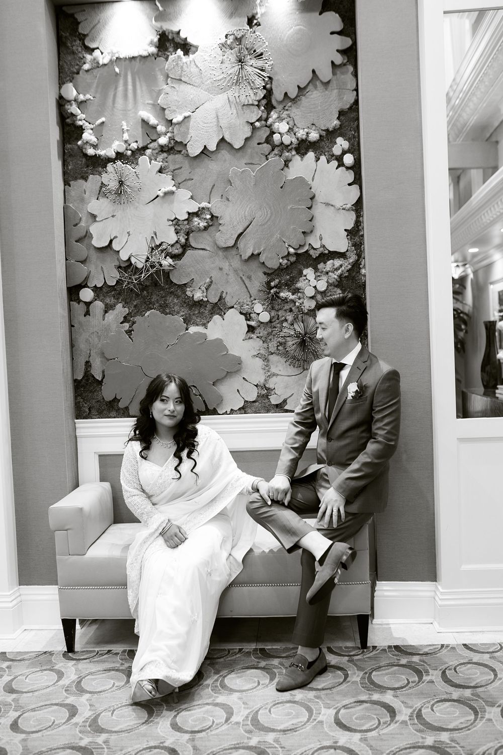 An artistic black and white photo sequence of a couple sitting against a decorative wall. at Jericho Terrace
