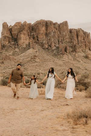 Family walking together beneath desert mountains in Buckeye Arizona.